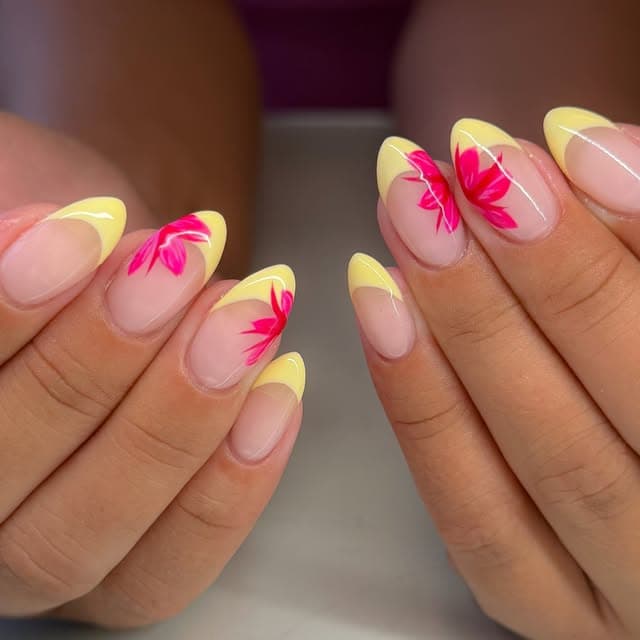 Yellow manicure with hand-painted pink floral nail art