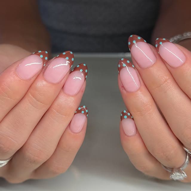Soft pink manicure with glitter and crystal accent nails
